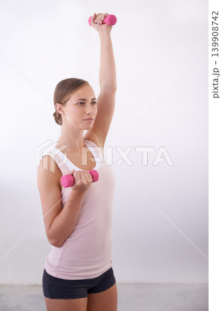 Woman, arm lift and dumbbell for weight training at home with exercise, smile and workout. Happy, wellness and gym equipment for health and sport with fitness for strength and confidence in house 139908742