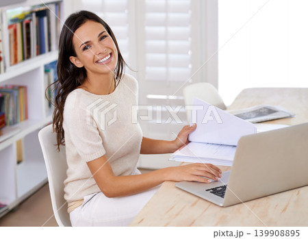 Documents, smile and portrait of woman with laptop working on creative project at home office. Happy, technology and female freelance designer with paperwork and computer in workspace at apartment. Documents, smile and portrait of woman with laptop working on creative project at home office. Happy, technology and female freelance designer with paperwork and computer in workspace at apartment. 139908895