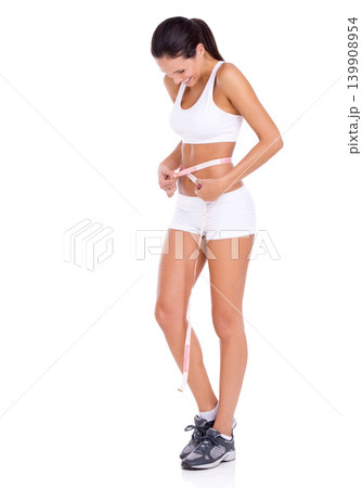 Measuring tape, lose weight and woman on a white background for wellness, healthy body and diet. Weightloss, happy and isolated person measure waist for fitness, exercise or workout results in studio 139908954