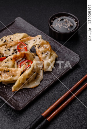 Gyoza, Chinese or Japanese meat dumplings, is an Asian food with hot peppers. Gyoza with meat 139909162