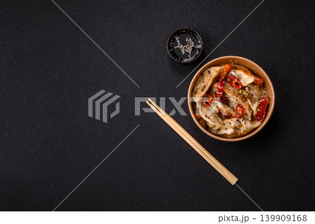 Gyoza, Chinese or Japanese meat dumplings, is an Asian food with hot peppers. Gyoza with meat Gyoza, Chinese or Japanese meat dumplings, is an Asian food with hot peppers. Gyoza with meat 139909168