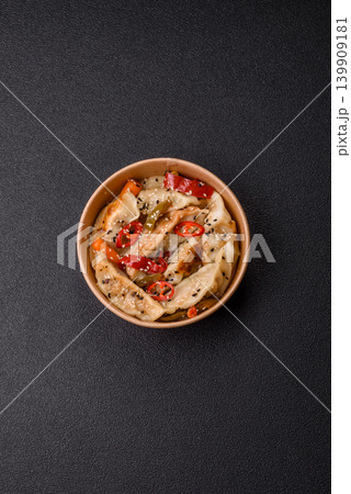 Gyoza, Chinese or Japanese meat dumplings, is an Asian food with hot peppers. Gyoza with meat Gyoza, Chinese or Japanese meat dumplings, is an Asian food with hot peppers. Gyoza with meat 139909181