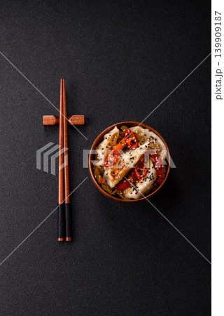Gyoza, Chinese or Japanese meat dumplings, is an Asian food with hot peppers. Gyoza with meat Gyoza, Chinese or Japanese meat dumplings, is an Asian food with hot peppers. Gyoza with meat 139909187