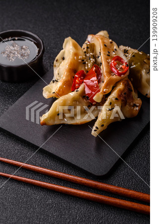 Gyoza, Chinese or Japanese meat dumplings, is an Asian food with hot peppers. Gyoza with meat 139909208