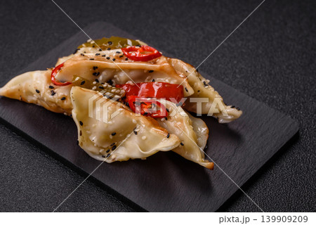 Gyoza, Chinese or Japanese meat dumplings, is an Asian food with hot peppers. Gyoza with meat 139909209