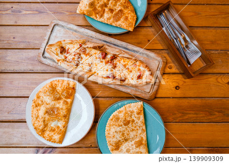pizza pide and chebureks on wooden table top view 139909309