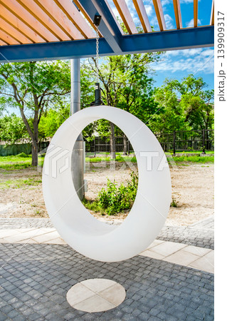 oval white plastic swing in the recreation area oval white plastic swing in the recreation area 139909317