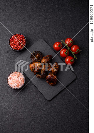 Grilled or barbecued mushroom halves with salt and spices. Grilled mushrooms Grilled or barbecued mushroom halves with salt and spices. Grilled mushrooms 139909571