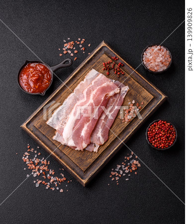 Raw fresh bacon slices with layers of meat or prosciutto with salt and spices. Raw bacon 139909826