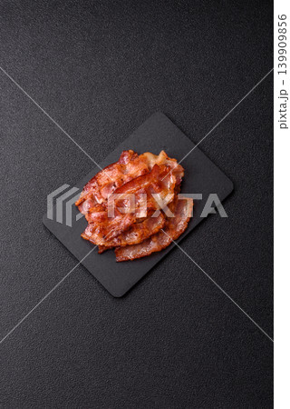 Fried fresh bacon slices with layers of meat or prosciutto with salt and spices. Fried bacon Fried fresh bacon slices with layers of meat or prosciutto with salt and spices. Fried bacon 139909856