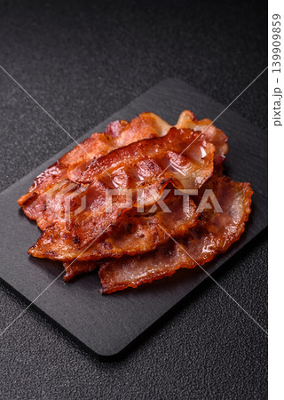 Fried fresh bacon slices with layers of meat or prosciutto with salt and spices. Fried bacon Fried fresh bacon slices with layers of meat or prosciutto with salt and spices. Fried bacon 139909859