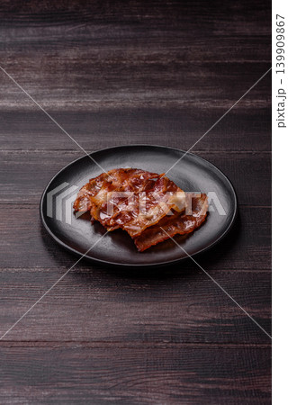 Fried fresh bacon slices with layers of meat or prosciutto with salt and spices. Fried bacon Fried fresh bacon slices with layers of meat or prosciutto with salt and spices. Fried bacon 139909867