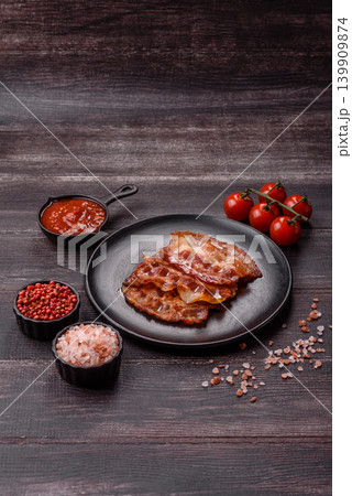 Fried fresh bacon slices with layers of meat or prosciutto with salt and spices. Fried bacon 139909874