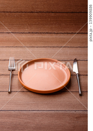 An empty ceramic round plate, kitchen utensils for a dinner table. An empty plate An empty ceramic round plate, kitchen utensils for a dinner table. An empty plate 139909886