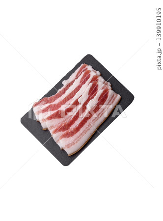 Raw fresh bacon slices with layers of meat or prosciutto prepared for frying. Raw bacon Raw fresh bacon slices with layers of meat or prosciutto prepared for frying. Raw bacon 139910195