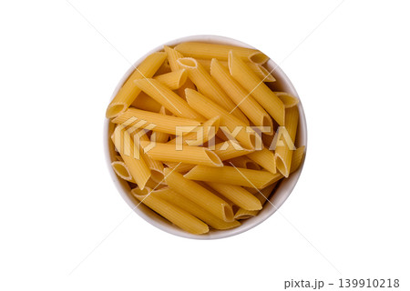 Italian uncooked dry penne regate pasta ready for cooking. Dry penne pasta Italian uncooked dry penne regate pasta ready for cooking. Dry penne pasta 139910218
