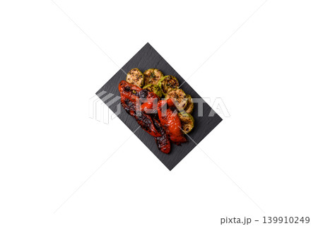 Grilled or barbecued sweet peppers and zucchini slices with salt. Grilled peppers and zucchini Grilled or barbecued sweet peppers and zucchini slices with salt. Grilled peppers and zucchini 139910249