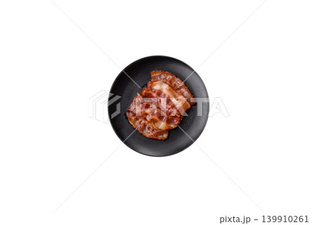 Fried fresh bacon slices with layers of meat or prosciutto with salt and spices. Fried bacon Fried fresh bacon slices with layers of meat or prosciutto with salt and spices. Fried bacon 139910261