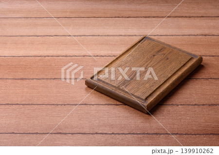 Empty wooden cutting board for preparing ingredients for home cooking. An empty cutting board 139910262