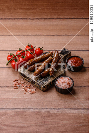 Thin chicken or pork sausages grilled or barbecued. Grilled sausages 139910355