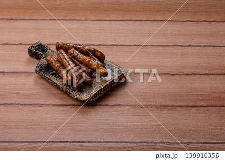 Thin chicken or pork sausages grilled or barbecued. Grilled sausages 139910356