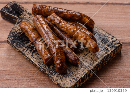 Thin chicken or pork sausages grilled or barbecued. Grilled sausages Thin chicken or pork sausages grilled or barbecued. Grilled sausages 139910359