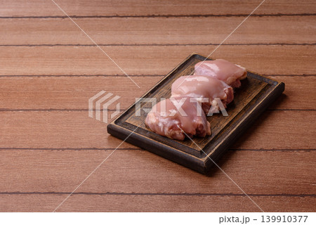 Raw chicken thigh fillet, boneless and skinless, for roasting. Raw thigh fillet 139910377