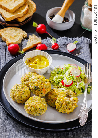 baked meat and vegetable polpette on a plate 139910488