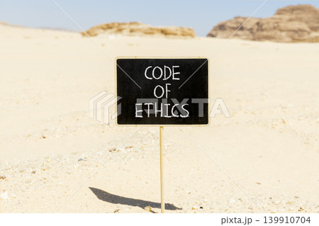 Code of ethics words symbol. Concept words Code of ethics on beautiful blackboard. Beautiful Sinai desert sand background. Business Code of ethics concept. Copy space. Code of ethics words symbol. Concept words Code of ethics on beautiful blackboard. Beautiful Sinai desert sand background. Business Code of ethics concept. Copy space. 139910704