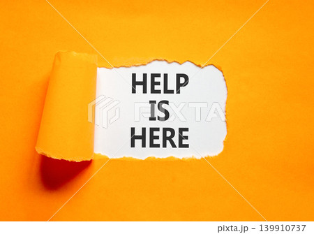 Help is here and support words symbol. Concept words Help is here on beautiful white paper. Beautiful orange background. Business help is here and support concept. Copy space. 139910737