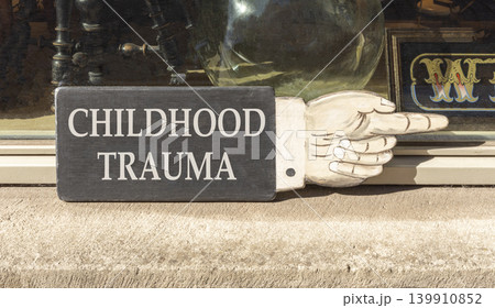 Childhood trauma words symbol. Concept words Childhood trauma on beautiful black wooden sign. Beautiful shopfront background. Psychological childhood trauma support concept. Copy space. 139910852