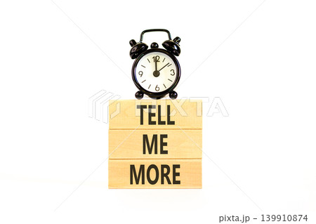 Tell me more words symbol. Concept words Tell me more on beautiful wooden blocks. Beautiful white background. Black alarm clock. Business and tell me more concept. Copy space. Tell me more words symbol. Concept words Tell me more on beautiful wooden blocks. Beautiful white background. Black alarm clock. Business and tell me more concept. Copy space. 139910874