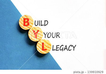 BYL build your legacy symbol. Concept words BYL build your legacy on beautiful wooden circles. Beautiful white blue background. Business BYL build your legacy concept. Copy space 139910929