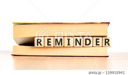 Reminder word symbol. Concept word Reminder on beautiful wooden blocks in beautiful book. Beautiful wooden table white background. Business support help reminder word concept. Copy space. Reminder word symbol. Concept word Reminder on beautiful wooden blocks in beautiful book. Beautiful wooden table white background. Business support help reminder word concept. Copy space. 139910941