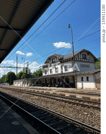 Train station building with traditional architecture and platform, surrounded by trees and Train station building with traditional architecture and platform, surrounded by trees and 139911180