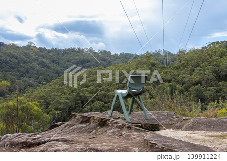 A plastic chair abandoned on a rock plateau in a forest A plastic chair abandoned on a rock plateau in a forest 139911224