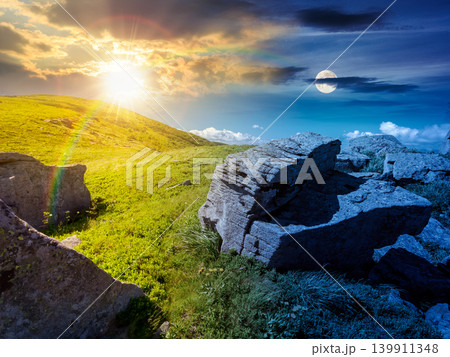 day meet night above Carpathian mountain summer landscape. sun and moon in harmony over meadow with stones among the grass on hillside near the peak of mountain range. alpine meadow and rolling hills 139911348