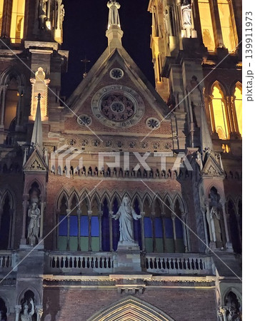 Cordoba, Argentina - April 12, 2026: neo-gothic spire and illuminated bell tower of Iglesia de Los Capuchinos in Cordoba. Cordoba, Argentina - April 12, 2026: neo-gothic spire and illuminated bell tower of Iglesia de Los Capuchinos in Cordoba. 139911973