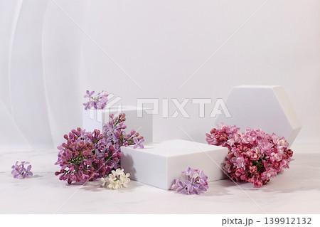 Empty product podium and fresh live spring flowers.Abstract beautiful flower arrangement with lilac blossoms,banner.Stage for business concept.Minimal modern aesthetics and elegant beauty concept Empty product podium and fresh live spring flowers.Abstract beautiful flower arrangement with lilac blossoms,banner.Stage for business concept.Minimal modern aesthetics and elegant beauty concept 139912132