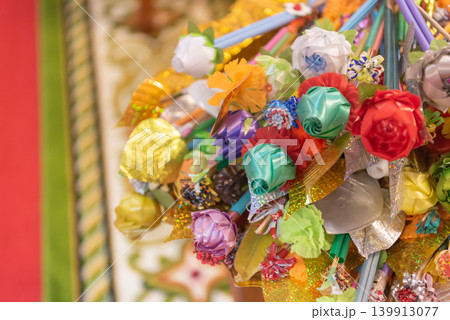 Colorful kathin money tree made from paper flowers sticks used for buddhist donation ceremony festive decoration vibrant handmade craft closeup detail 139913077