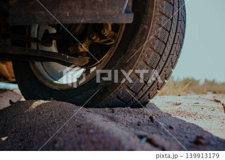 Car wheel on sand close-up view Car wheel on sand close-up view 139913179