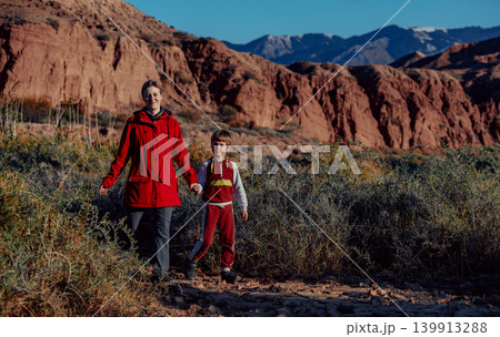 Mother and son walking on mountains background at autumn 139913288