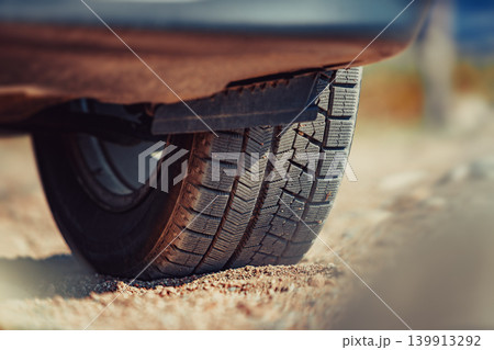 Car wheel on sand close-up view Car wheel on sand close-up view 139913292