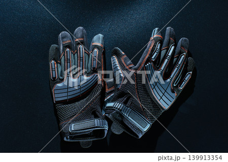 Protective work gloves on black background Protective work gloves on black background 139913354