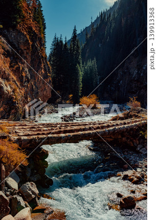 Autumn mountain landscape with wooden bridge over the river Autumn mountain landscape with wooden bridge over the river 139913368