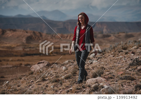 Young woman tourist walks in the mountains Young woman tourist walks in the mountains 139913492