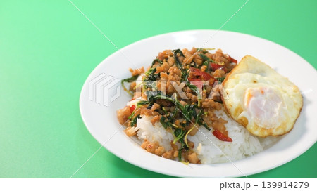 stir fried pork with holy basil on top with fried egg on cooked rice stir fried pork with holy basil on top with fried egg on cooked rice 139914279