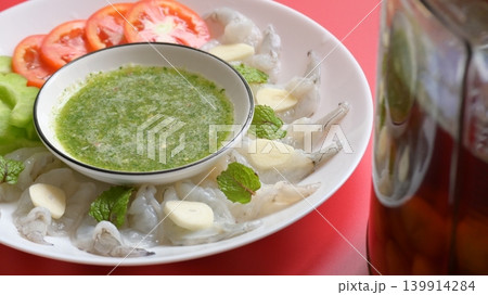 shrimp in fish sauce with Thai spicy seafood dipping sauce on white plate and umeshu 139914284