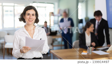 European woman gets a job in a company and holds a resume in her hands European woman gets a job in a company and holds a resume in her hands 139914497