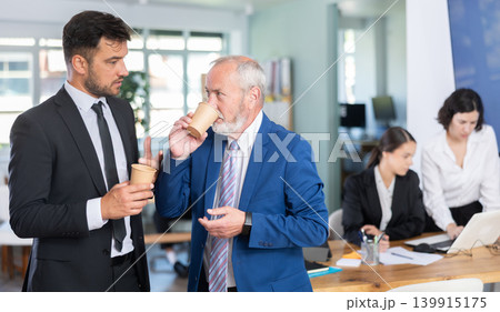 managers of the bank office discuss work issues during a coffee break managers of the bank office discuss work issues during a coffee break 139915175